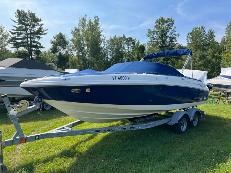 Slide: The Image of 2007 Chaparral 220 SSi boat on trailer, parked on grass with trees in background. - 4