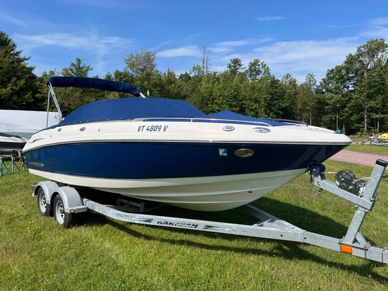 Slide: The Image of 2007 Chaparral 220 SSi boat on trailer, blue and white, parked on grass. - 5