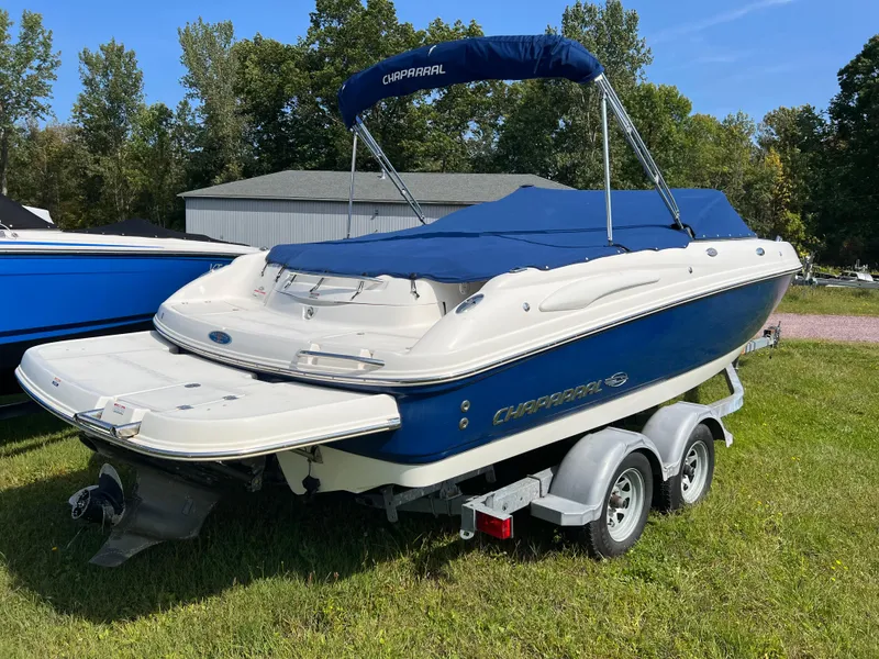 Slide: The Image of 2007 Chaparral 220 SSi boat on trailer, blue and white, parked on grass. - 6