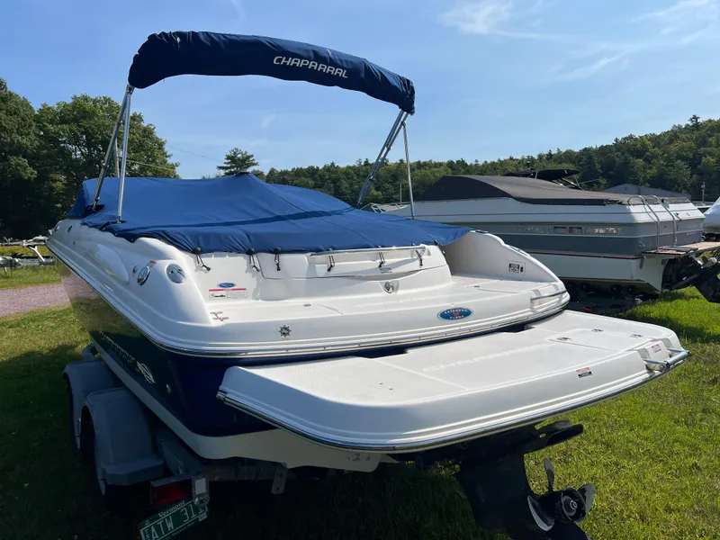 Slide: The Image of 2007 Chaparral 220 SSi boat with blue cover on trailer, parked on grass. - 7