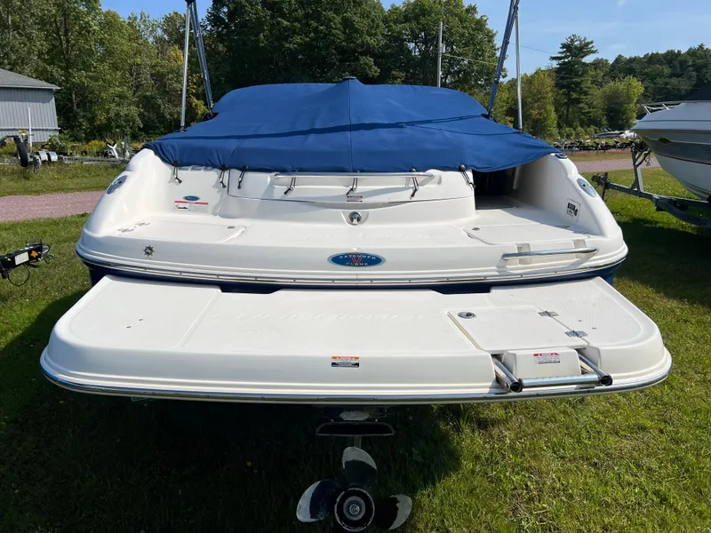 Slide: The Image of 2007 Chaparral 220 SSi boat with blue cover, parked on grass. - 8