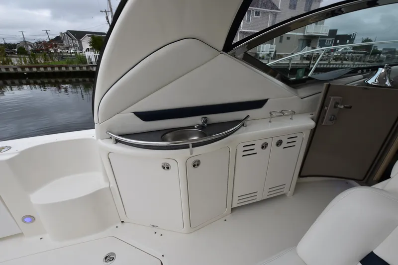Slide: The Image of 2005 Sea Ray 420 Sundancer yacht interior with sink and storage cabinets. - 13