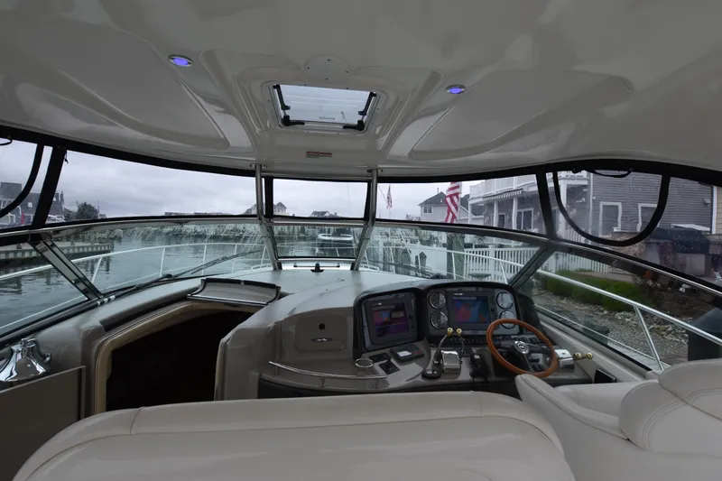 Slide: The Image of 2005 Sea Ray 420 Sundancer yacht interior with modern dashboard and steering wheel. - 16