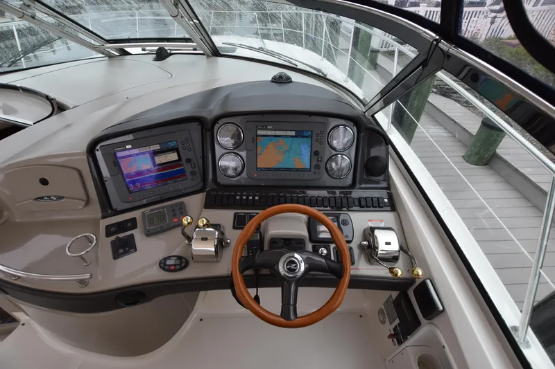 Slide: The Image of 2005 Sea Ray 420 Sundancer helm with navigation screens and controls. - 17