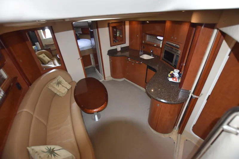 Slide: The Image of Interior of 2005 Sea Ray 420 Sundancer yacht with kitchen and seating area. - 21
