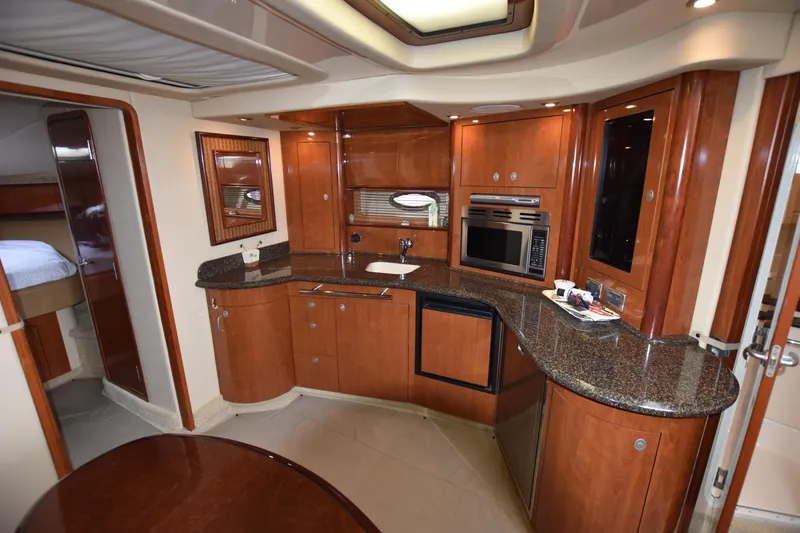 Slide: The Image of Luxurious 2005 Sea Ray 420 Sundancer yacht interior with modern kitchen amenities. - 22