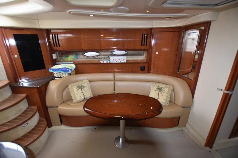 Slide: The Image of Interior of 2005 Sea Ray 420 Sundancer yacht with elegant seating and wooden table. - 23