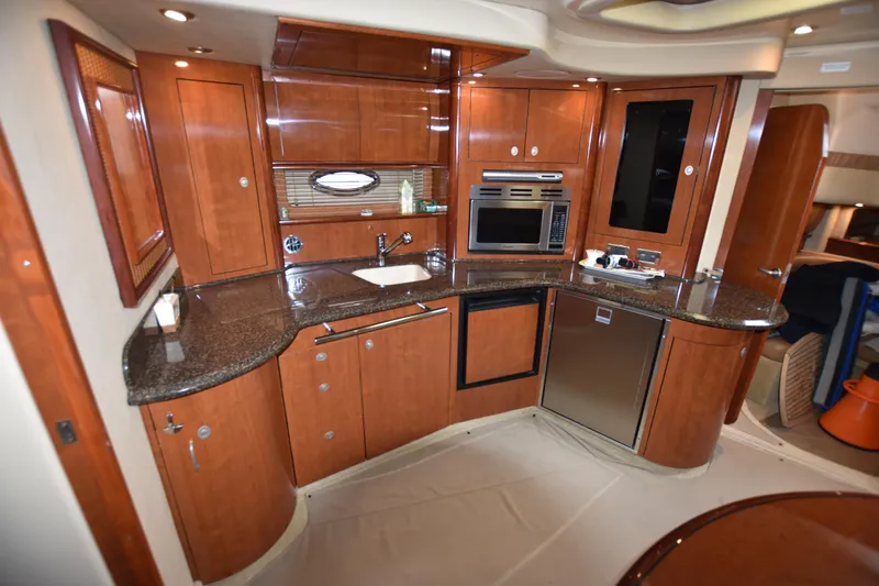 Slide: The Image of Luxurious kitchen interior of 2005 Sea Ray 420 Sundancer yacht with wood cabinetry. - 24