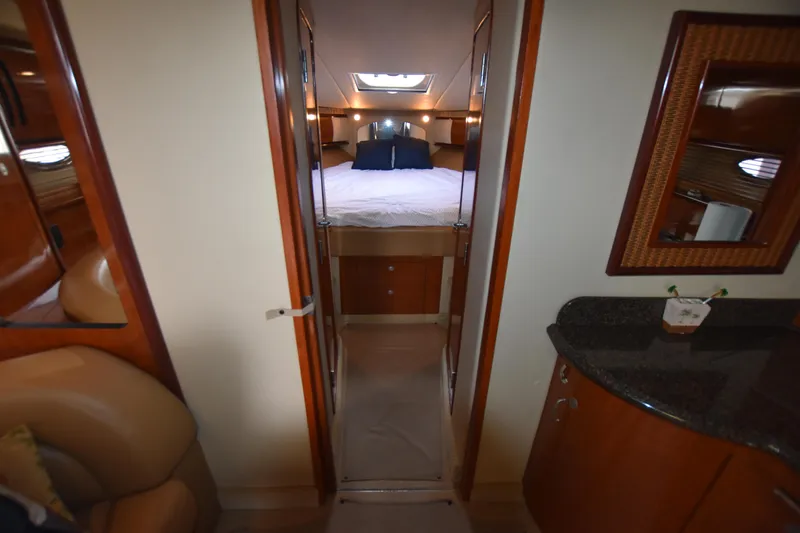 Slide: The Image of Interior view of 2005 Sea Ray 420 Sundancer cabin with bed and wooden furnishings. - 25
