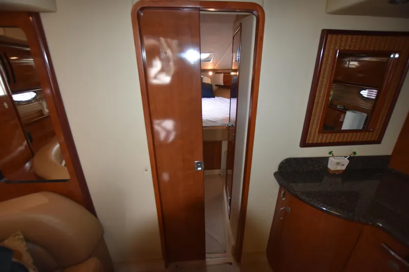 Slide: The Image of Interior view of 2005 Sea Ray 420 Sundancer cabin with wooden door and countertop. - 26