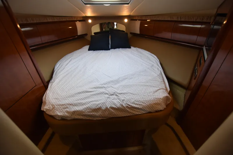Slide: The Image of Luxurious cabin interior of 2005 Sea Ray 420 Sundancer with cozy bed and elegant wood finish. - 27