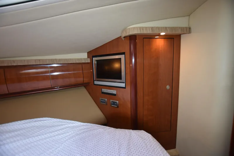 Slide: The Image of 2005 Sea Ray 420 Sundancer cabin interior with TV and wooden cabinetry. - 28