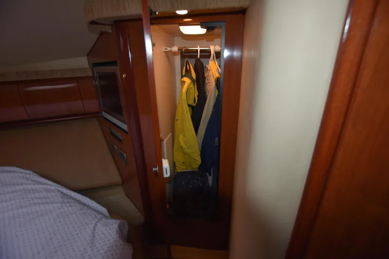 Slide: The Image of Interior closet of 2005 Sea Ray 420 Sundancer with hanging clothes. - 29