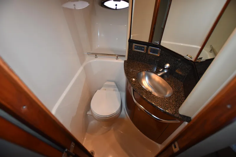 Slide: The Image of 2005 Sea Ray 420 Sundancer bathroom with modern sink and toilet, compact and stylish design. - 30