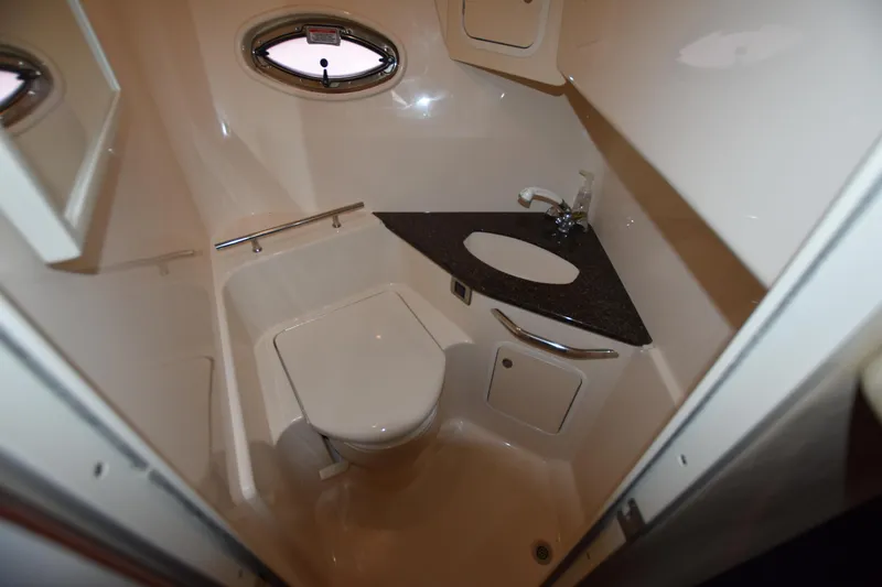 Slide: The Image of 2005 Sea Ray 420 Sundancer bathroom with modern fixtures and compact design. - 32