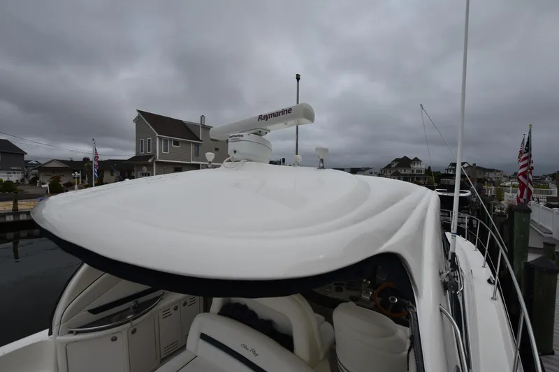 Slide: The Image of 2005 Sea Ray 420 Sundancer yacht docked under cloudy skies. - 33
