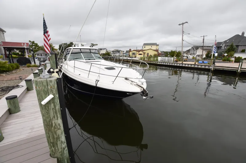 Slide: The Image of 2005 Sea Ray 420 Sundancer docked in a calm marina, overcast sky. - 39