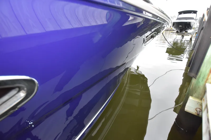 Slide: The Image of 2005 Sea Ray 420 Sundancer boat with sleek blue hull docked in marina. - 40