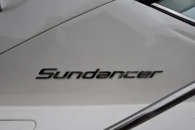 Slide: The Image of 2005 Sea Ray 420 Sundancer logo on white boat surface. - 42