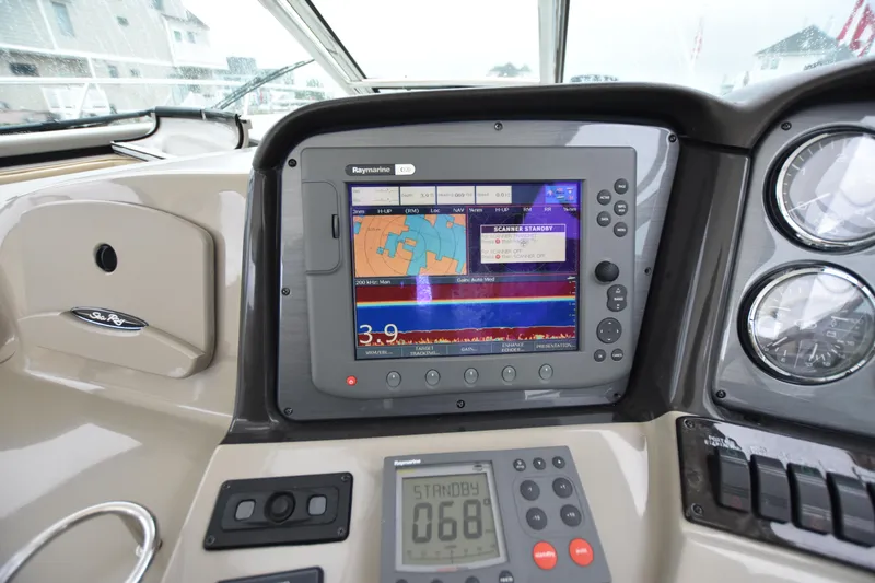 Slide: The Image of Dashboard of a 2005 Sea Ray 420 Sundancer with navigation display and controls. - 46