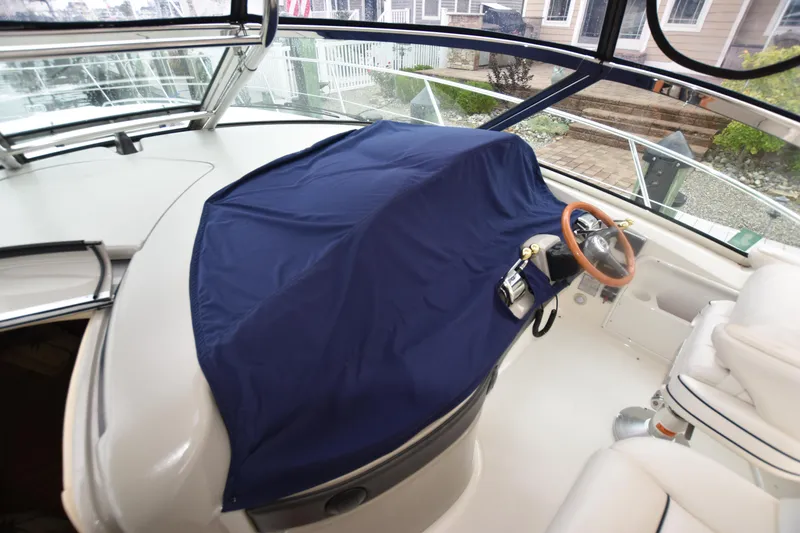 Slide: The Image of 2005 Sea Ray 420 Sundancer helm with blue cover, showcasing luxury yacht interior. - 48