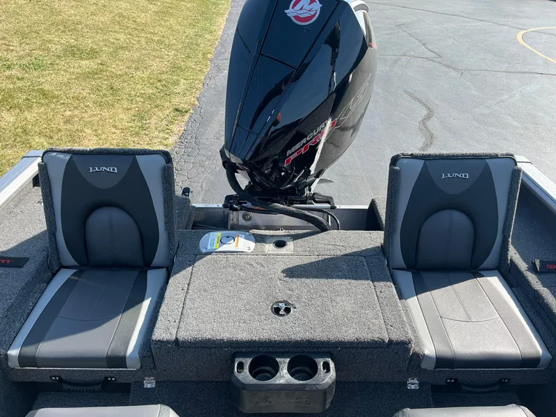 Slide: The Image of 2025 Lund 2075 Impact XS Sport boat interior with seating and motor. - 10