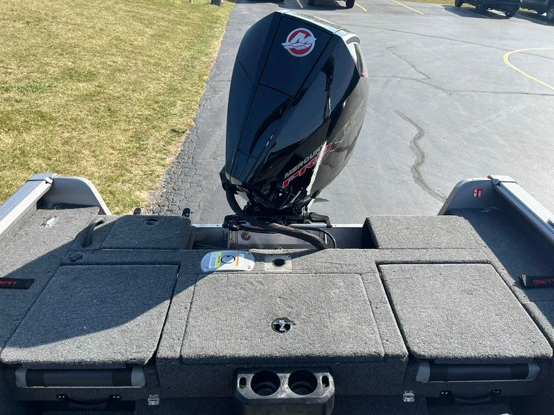 Slide: The Image of 2025 Lund 2075 Impact XS Sport boat with powerful outboard motor. - 11