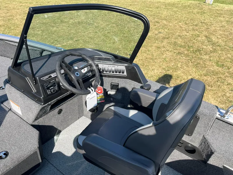 Slide: The Image of 2025 Lund 2075 Impact XS Sport boat interior with steering wheel and seat. - 13