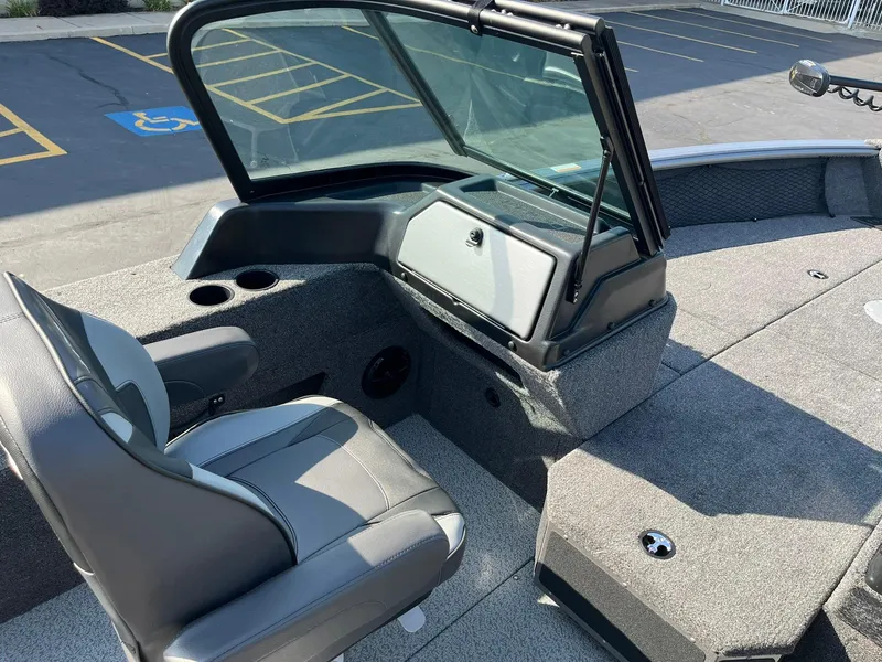 Slide: The Image of 2025 Lund 2075 Impact XS Sport boat interior with seating and dashboard. - 14