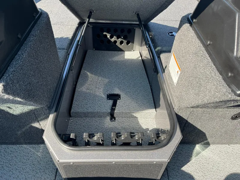 Slide: The Image of 2025 Lund 2075 Impact XS Sport boat storage compartment with open lid. - 16