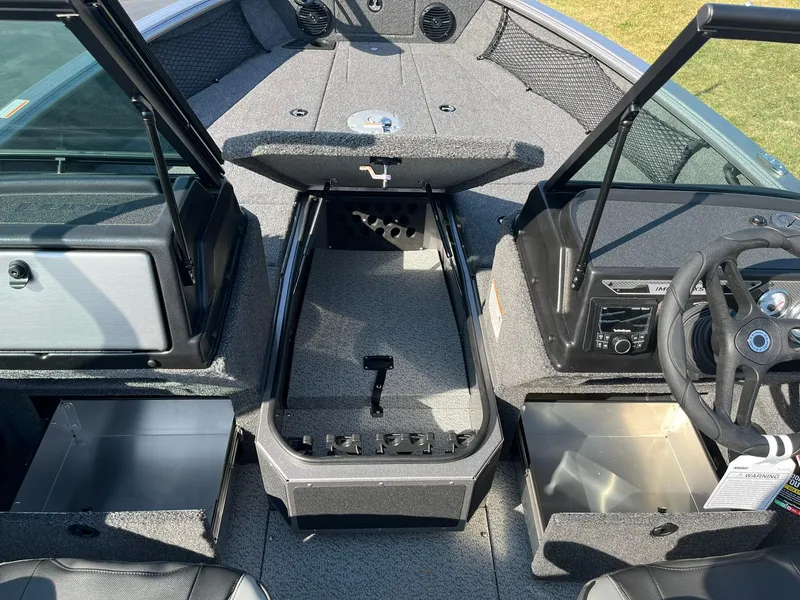 Slide: The Image of 2025 Lund 2075 Impact XS Sport boat interior with open storage compartments. - 17