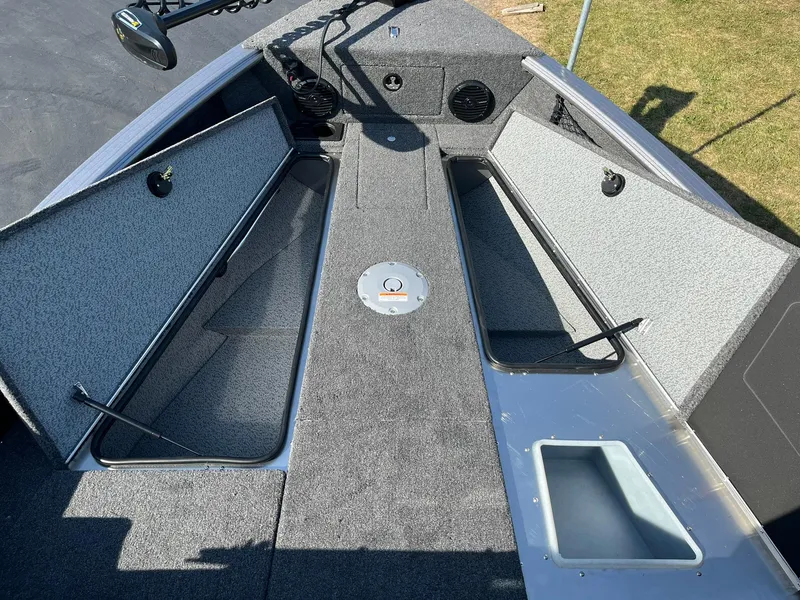 Slide: The Image of 2025 Lund 2075 Impact XS Sport boat interior with open storage compartments. - 19