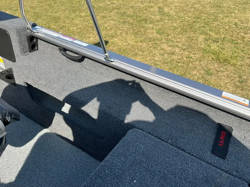 Slide: The Image of 2025 Lund 2075 Impact XS Sport boat interior with shadow on carpeted floor. - 26