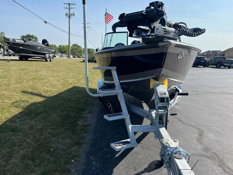 Slide: The Image of 2025 Lund 2075 Impact XS Sport boat on trailer, parked outdoors. - 5