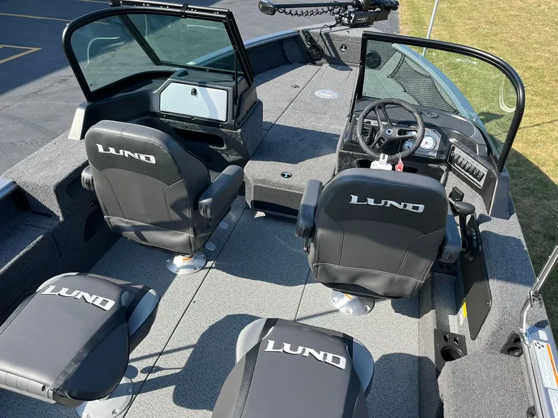 Slide: The Image of 2025 Lund 2075 Impact XS Sport boat interior with seating and steering console. - 8