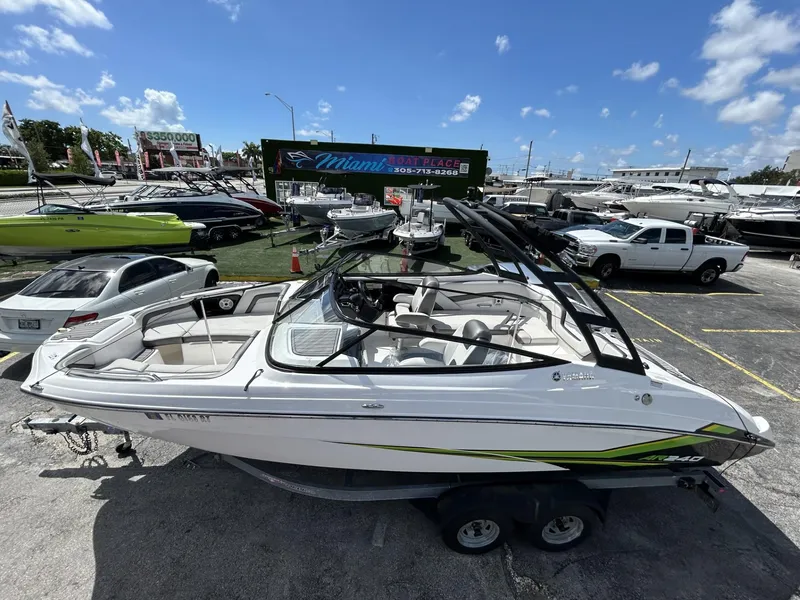 Slide: The Image of 2019 Yamaha AR240 boat on trailer in marina under clear sky. - 10