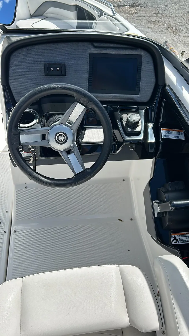 Slide: The Image of 2019 Yamaha AR240 boat cockpit with steering wheel and dashboard controls. - 19
