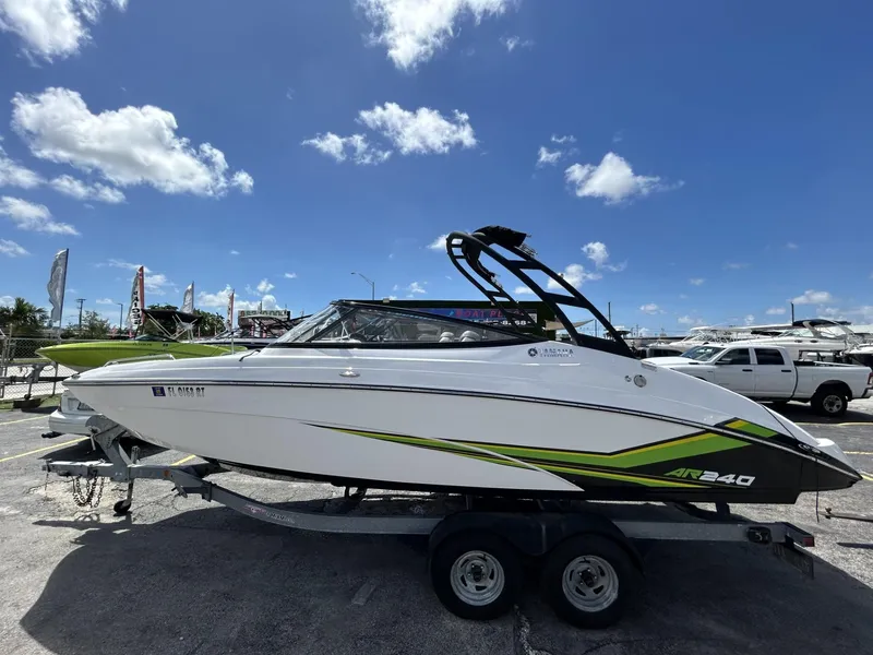 Slide: The Image of 2019 Yamaha AR240 boat on trailer under clear blue sky. - 2
