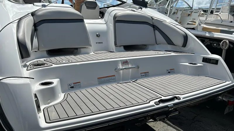 Slide: The Image of 2019 Yamaha Boats AR240 rear deck with seating and storage compartments. - 20