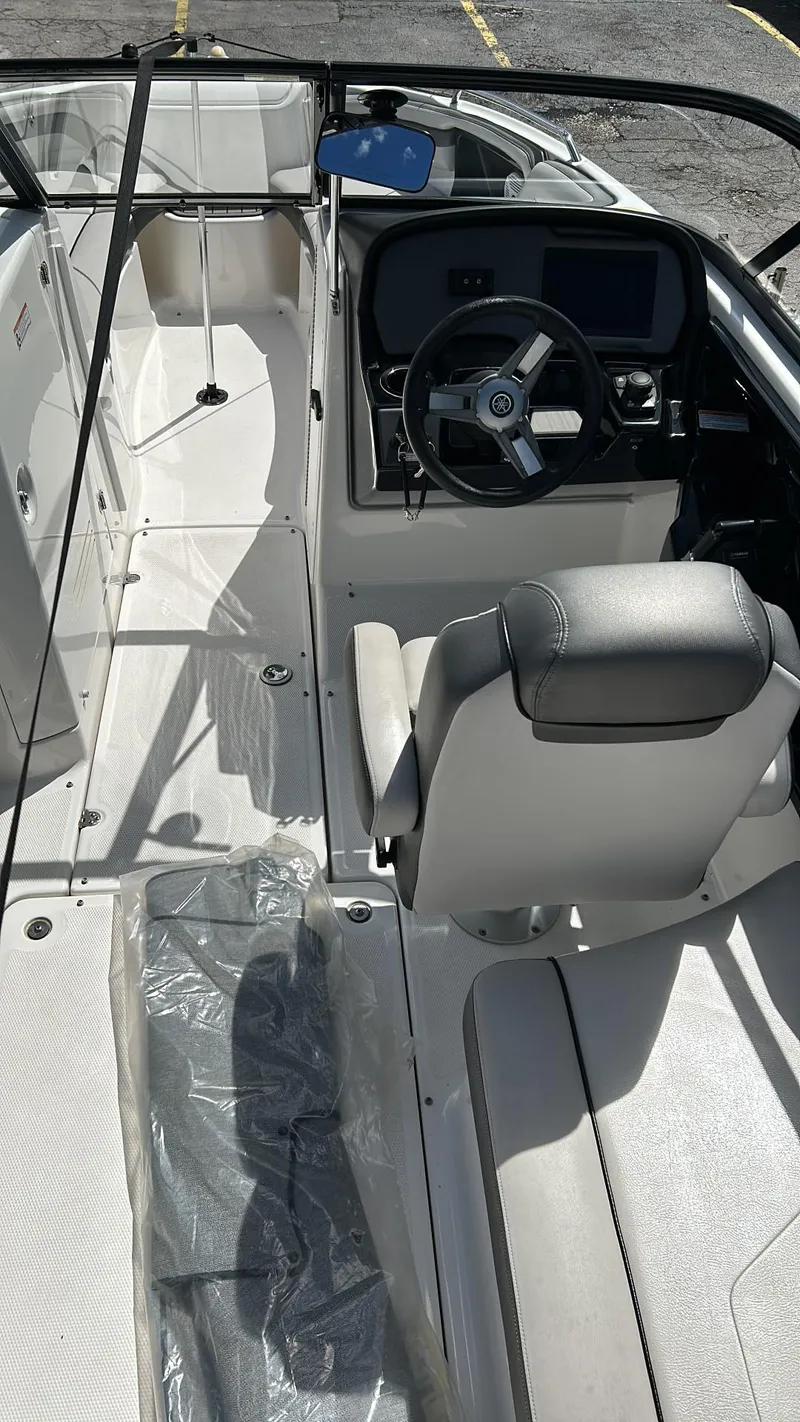 Slide: The Image of 2019 Yamaha Boats AR240 interior with steering wheel and seating. - 21