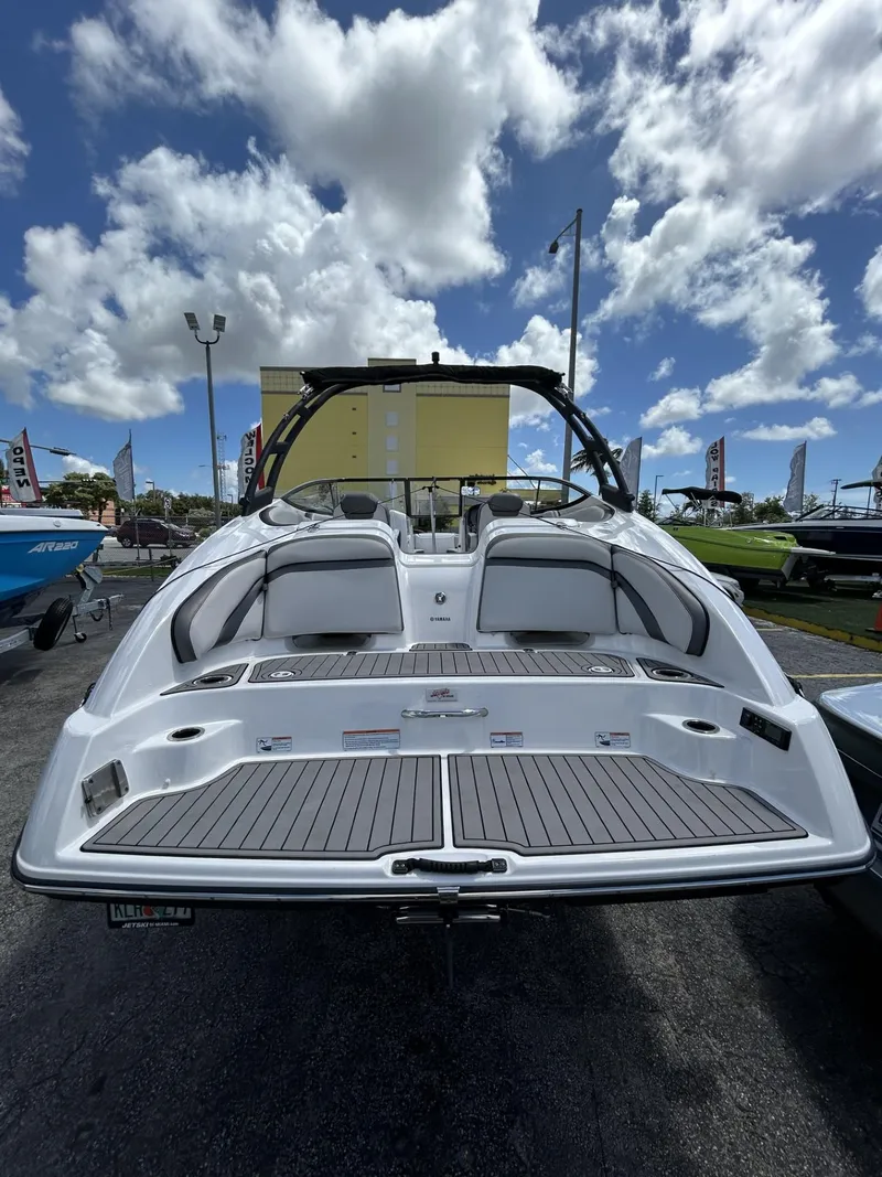 Slide: The Image of 2019 Yamaha AR240 boat, rear view, under a partly cloudy sky. - 22