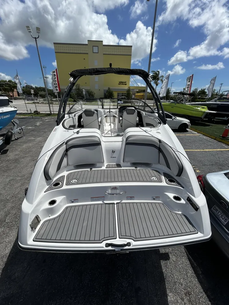 Slide: The Image of 2019 Yamaha Boats AR240, sleek design, spacious interior, parked outdoors under a blue sky. - 23