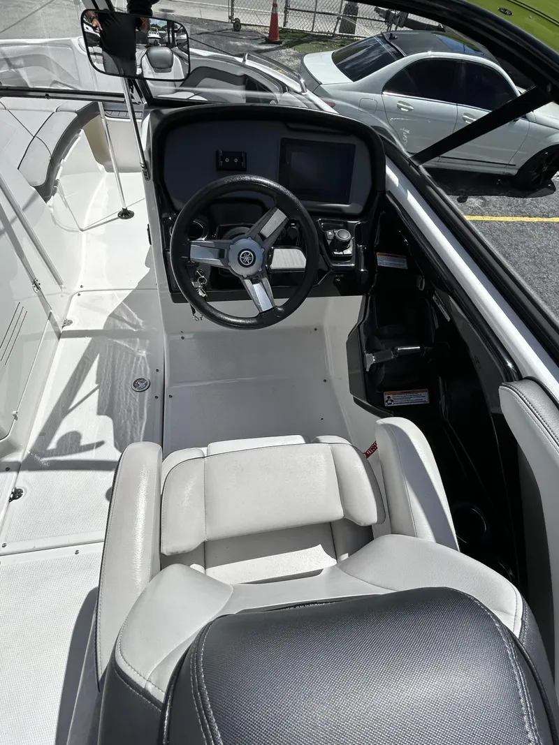 Slide: The Image of 2019 Yamaha AR240 boat cockpit with steering wheel and seating. - 28