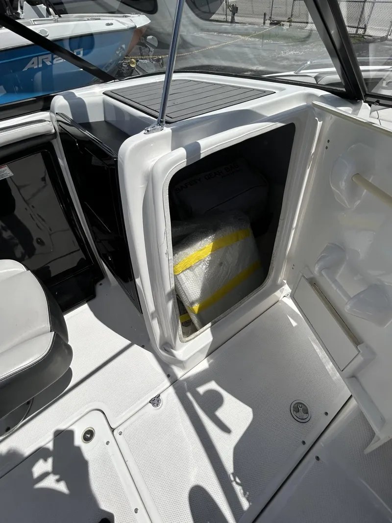 Slide: The Image of 2019 Yamaha Boats AR240 interior storage compartment with open door. - 29