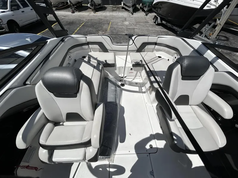 Slide: The Image of 2019 Yamaha Boats AR240 interior with dual captain's chairs and spacious seating. - 32