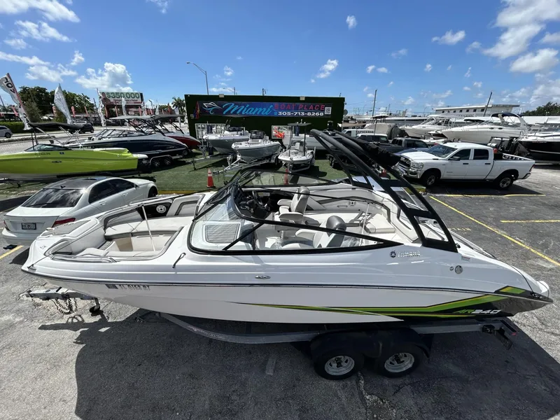 Slide: The Image of 2019 Yamaha AR240 boat displayed at a dealership under a clear blue sky. - 4