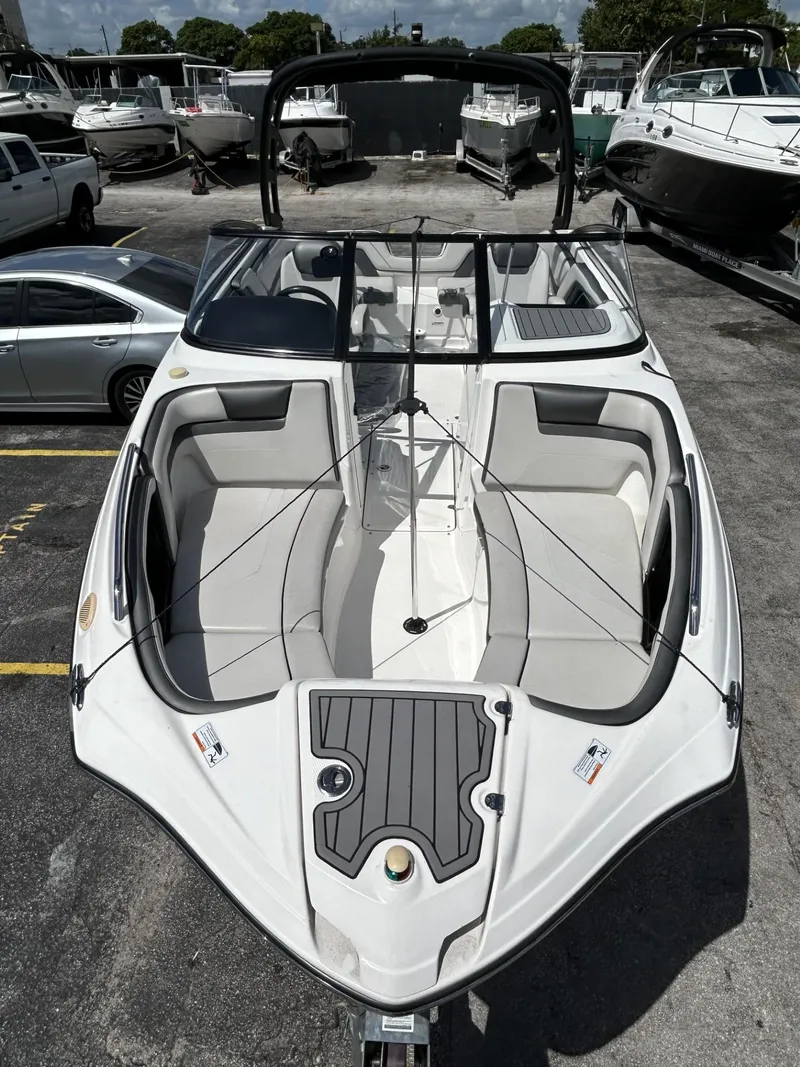 Slide: The Image of 2019 Yamaha AR240 boat with sleek design, parked in a marina. - 5