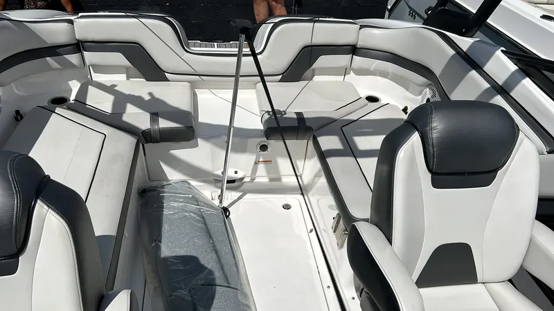 Slide: The Image of 2019 Yamaha Boats AR240 interior with white and gray seating, spacious layout. - 8