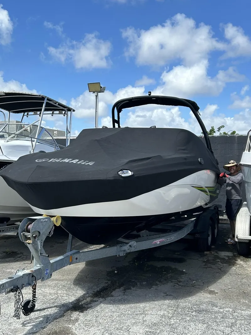Slide: The Image of 2019 Yamaha AR240 boat with cover on trailer, parked outdoors. - 9