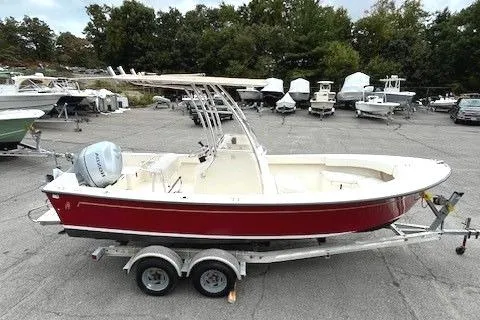 Slide: The Image of 2007 Bristol Harbor 21 CC boat on trailer, red hull, parked in a lot. - 2